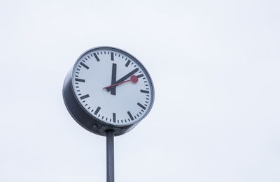 Low angle view of clock against white background