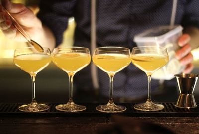 Midsection of bartender making drinks