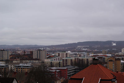 Cityscape against cloudy sky