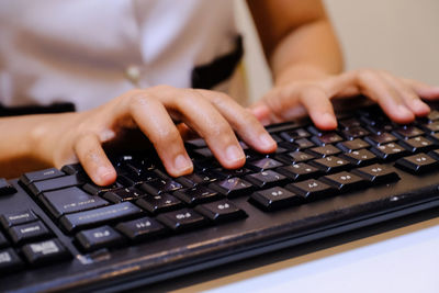 Midsection of woman using laptop