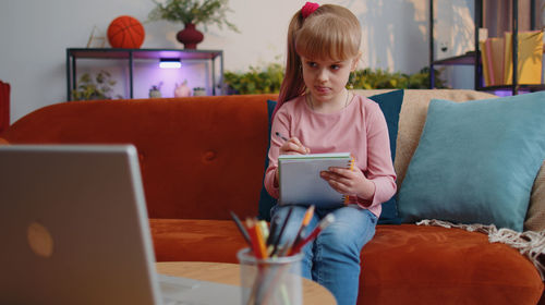 Young woman using laptop at home