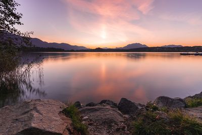 Scenic view of lake against sky during sunset