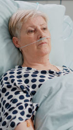 Portrait of young woman sleeping on bed at home