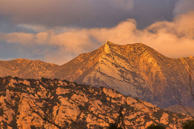 Scenic view of snowcapped mountains against sky during sunset