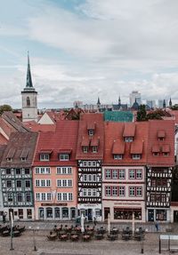 Clock tower in city against sky