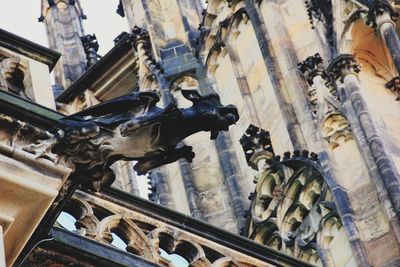 Low angle view of statue against historic building