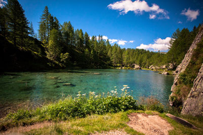 Scenic view of lake at alpe devero natural park against blue sky