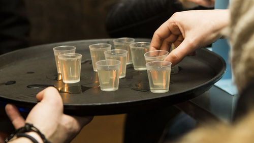 Cropped image of bartender serving drinks