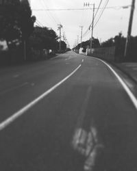 Empty road along trees