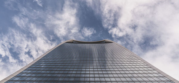 Low angle view of building against cloudy sky