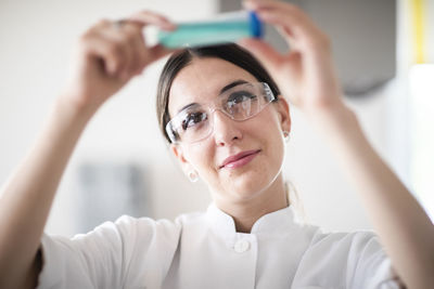 Scientist female with lab glasses, tablet and sample in a lab