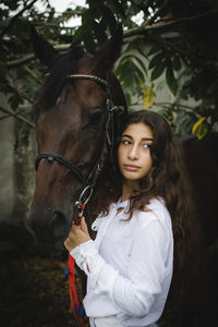 Portrait of young woman riding horse