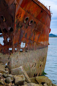 Abandoned boat on sea shore