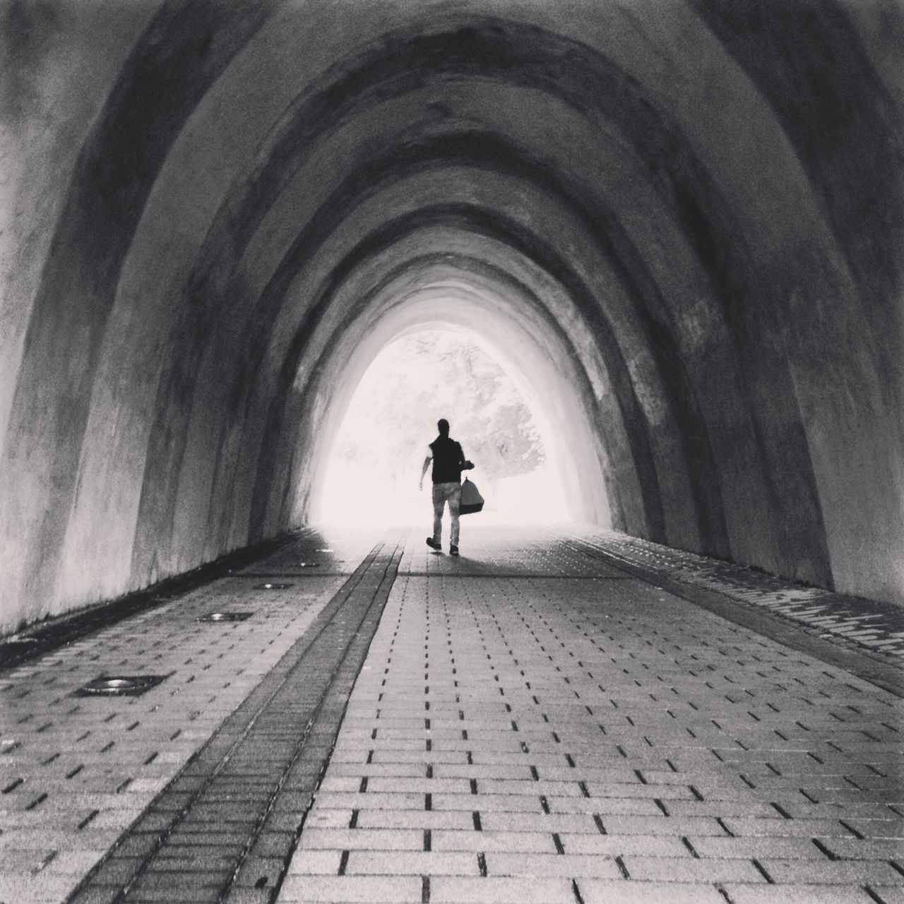 arch, indoors, the way forward, rear view, full length, architecture, tunnel, built structure, lifestyles, walking, men, diminishing perspective, silhouette, standing, archway, leisure activity, day, corridor