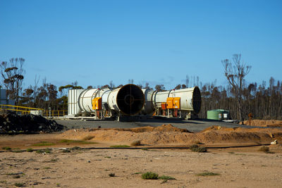 Truck on field against clear sky