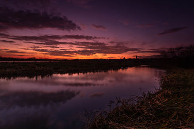 Scenic view of lake against romantic sky at sunset