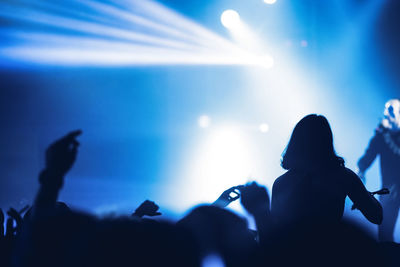 Group of silhouette people at music concert