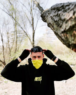 Portrait of young man standing on snow