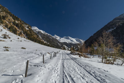 Scenic view of snow covered mountains against sky