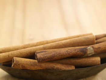 Close-up of cinnamons in bowl on table