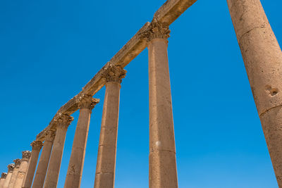 Low angle view of old ruin against blue sky