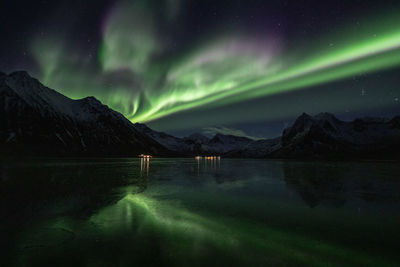 Scenic view of lake against sky at night