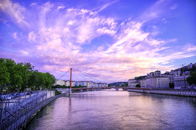 View of bridge over river against cloudy sky