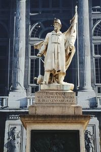 Low angle view of statue against building