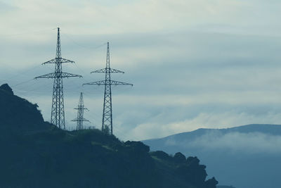 Low angle view of electricity pylon against sky