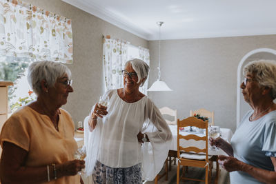 Smiling senior women standing in living room