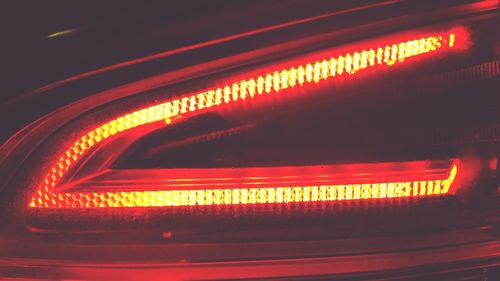 Close-up of illuminated headlight on car