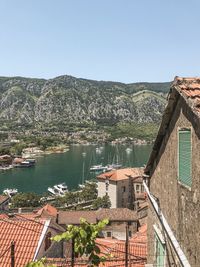 High angle view of buildings in town against clear sky