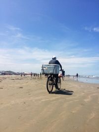 People riding bicycle on beach