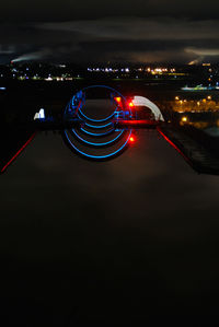 Illuminated cityscape against sky at night