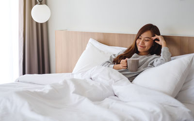 Young woman sleeping on bed at home