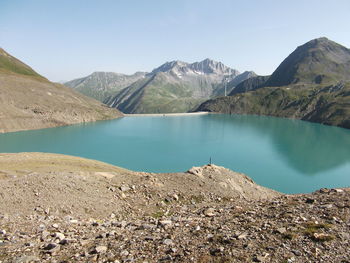 Scenic view of lake and mountains against sky