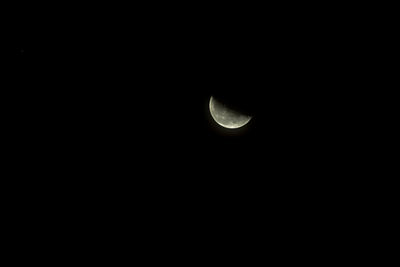 Low angle view of moon in the dark