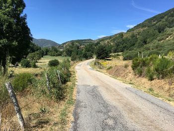 Empty road along countryside landscape