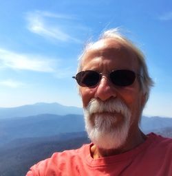 Portrait of man wearing sunglasses against sky