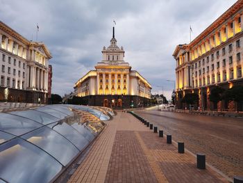 Street amidst buildings against sky in city