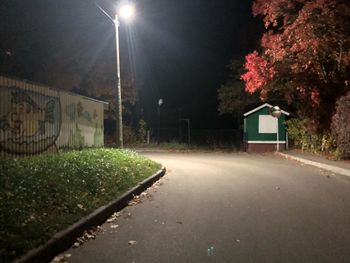 Street by building against sky at night