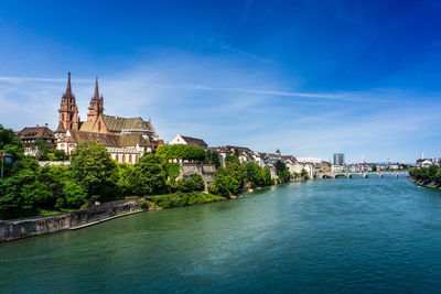 River by church in city against sky