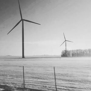 Windmills against sky