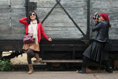 Full length of young couple photographing