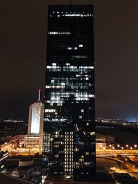 Low angle view of skyscrapers lit up at night