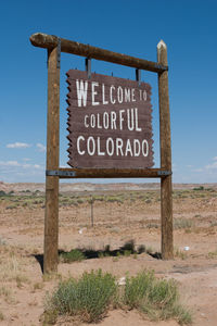 Information sign on landscape against sky