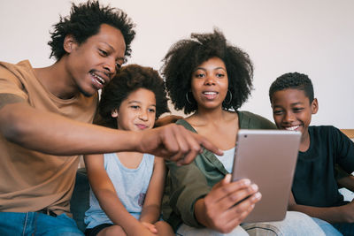 Happy friends sitting on smart phone