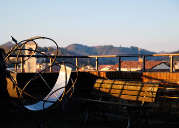 Old boat moored on shore against sky