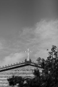 Low angle view of tower and building against sky