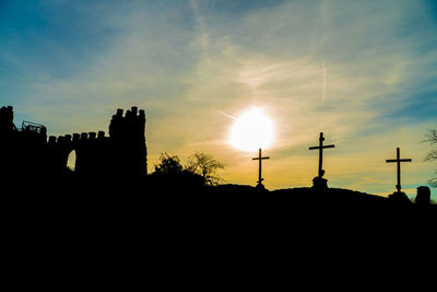 Silhouette buildings against sky during sunset